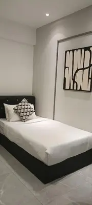 a bedroom with a large bed in a room at Elite Suites at Agile Bukit Bintang Kuala Lumpur in Kuala Lumpur