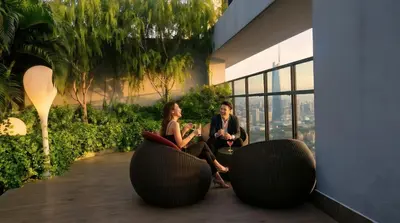 a man and a woman sitting in a building at THRÉS Signature - Trion KL in Kuala Lumpur
