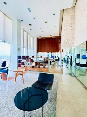 a lobby with a table and chairs in a building at The Grand klcc at platinum face in Kuala Lumpur