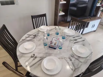 a table with plates and water bottles on it at KL Suites At Star KLCC in Kuala Lumpur