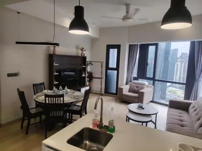 a kitchen and living room with a sink and a table at KL Suites At Star KLCC in Kuala Lumpur