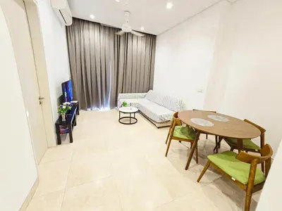 a living room with a table and a couch at Glowing Star Home Infinity Swimming Pool By Lalaport in Kuala Lumpur