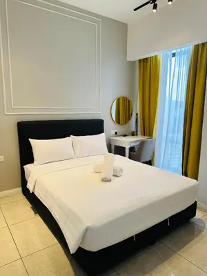 a bedroom with a large white bed with a window at Luxury Residence At Axon in Kuala Lumpur