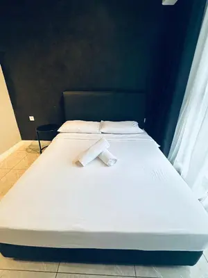 a large white bed with two towels on it at Luxury Residence At Axon in Kuala Lumpur