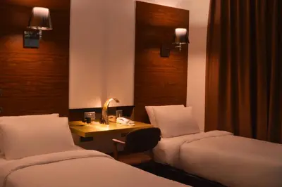 a hotel room with two beds and a desk at Melange Boutique Hotel Bukit Bintang in Kuala Lumpur