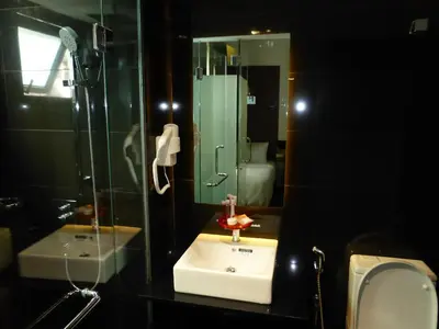a bathroom with a sink and a shower and a mirror at Melange Boutique Hotel Bukit Bintang in Kuala Lumpur