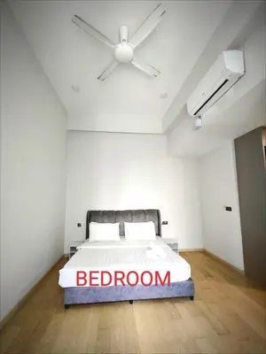a bedroom with a bed with a ceiling fan at Star Residences Suites Home in Kuala Lumpur