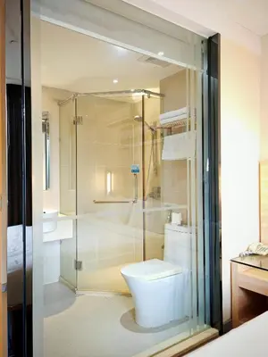 a bathroom with a toilet and a glass shower at City Comfort Hotel Kuala Lumpur City Center (Bukit Bintang) in Kuala Lumpur