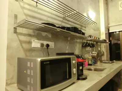 a microwave sitting on a counter in a kitchen at Revopackers Beds and Bunks in Kuala Lumpur