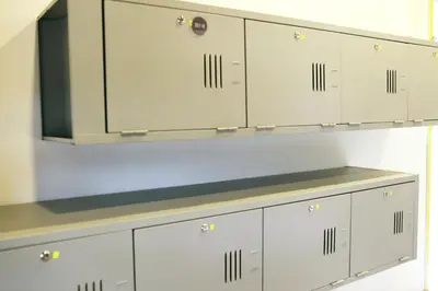 a row of white lockers in a locker room at Revopackers Beds and Bunks in Kuala Lumpur