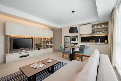 a living room with a couch and a table at Oasia Suites Kuala Lumpur by Far East Hospitality in Kuala Lumpur