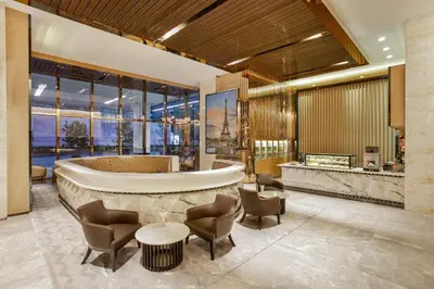 a lobby of a hotel with chairs and a bar at THE FACE Suites Hotel in Kuala Lumpur