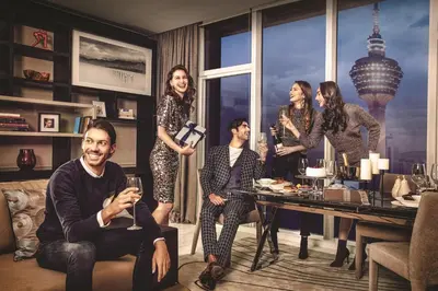 a group of people standing in a living room at THE FACE Suites Hotel in Kuala Lumpur
