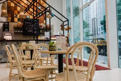 a row of chairs and a table in a restaurant at Verdant Hill Hotel Kuala Lumpur in Kuala Lumpur