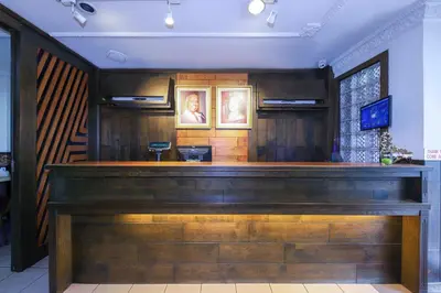 a bar in a restaurant with a wooden counter at Hotel O Madras in Kuala Lumpur