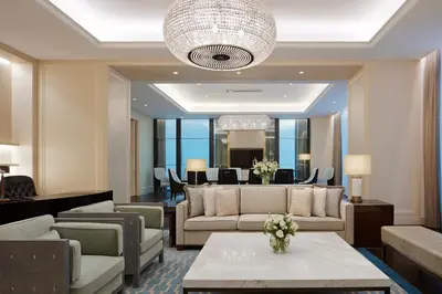 a lobby with couches and a table with flowers on it at The St. Regis Kuala Lumpur in Kuala Lumpur