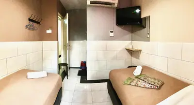 a bathroom with a bench and a tv on the wall at Adamson Park Kuala Lumpur in Kuala Lumpur