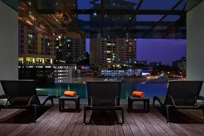 a balcony with two chairs and a view of a city at VE Hotel & Residence in Kuala Lumpur