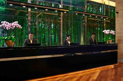 three men sitting at a counter with their laptops at VE Hotel & Residence in Kuala Lumpur