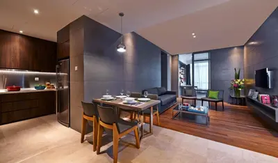 a kitchen and living room with a table and a couch at VE Hotel & Residence in Kuala Lumpur