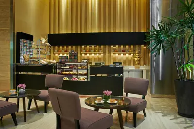 a restaurant with two tables and chairs and a counter at VE Hotel & Residence in Kuala Lumpur