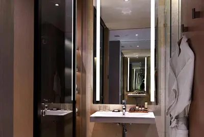 a bathroom with two sinks and two mirrors at VE Hotel & Residence in Kuala Lumpur