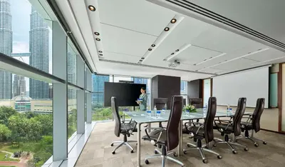 an office with a conference room with a table and chairs at Traders Hotel, Kuala Lumpur in Kuala Lumpur