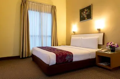 a hotel room with a large bed and a window at Hotel Sentral Kuala Lumpur at KL Sentral Station in Kuala Lumpur
