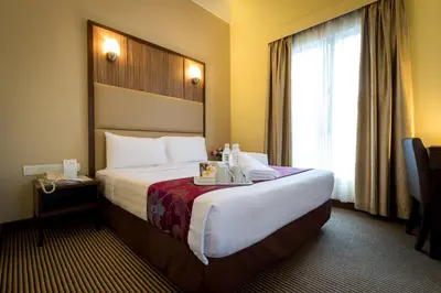 a hotel room with a large bed and a window at Hotel Sentral Kuala Lumpur at KL Sentral Station in Kuala Lumpur