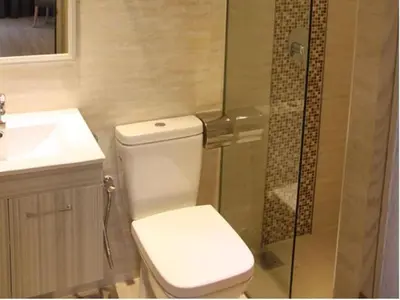 a bathroom with a toilet and a glass shower at NU Hotel @ KL Sentral in Kuala Lumpur