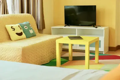 a living room with a couch and a tv and a table at Parkview KLCC Serviced Suites in Kuala Lumpur