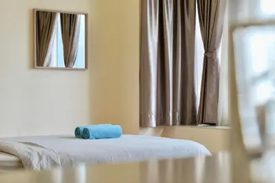a bed with a blue towel on it in a room at Parkview KLCC Serviced Suites in Kuala Lumpur