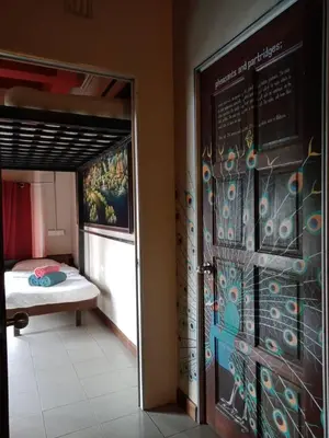 a room with a bed and a sign on the wall at Birdnest Guesthouse, Gaia Rooftop Cafe in Kuala Lumpur