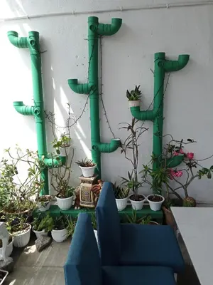 a room with green pipes and potted plants at Birdnest Guesthouse, Gaia Rooftop Cafe in Kuala Lumpur
