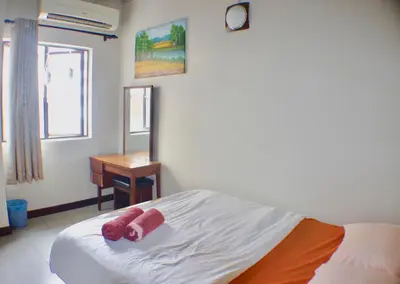 a bedroom with a bed with two red teddy bears on it at Birdnest Guesthouse, Gaia Rooftop Cafe in Kuala Lumpur