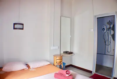 a bedroom with a bed and a mirror and a shower at Birdnest Guesthouse, Gaia Rooftop Cafe in Kuala Lumpur