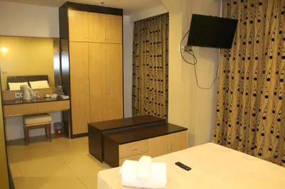 a hotel room with a bed and a desk and a television at T Hotel Jalan Tar in Kuala Lumpur
