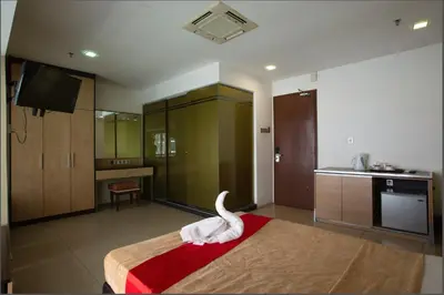 a room with a bed with a swan on it at T Hotel Jalan Tar in Kuala Lumpur