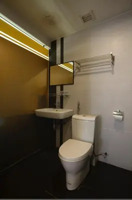 a bathroom with a toilet and a sink at T Hotel Jalan Tar in Kuala Lumpur