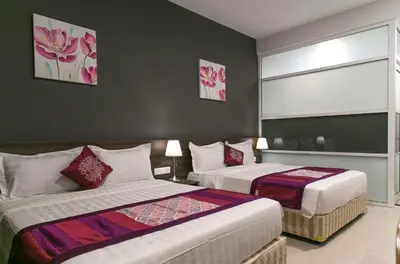a hotel room with two beds and a window at Lavana Hotel, Chinatown in Kuala Lumpur