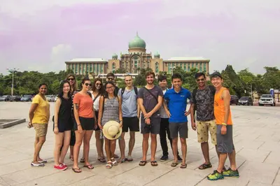 a group of people standing in front of a building at Chinatown Hostel by Mingle - Rooftop Private Jacuzzi with Bar in Kuala Lumpur