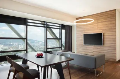 a living room with a table and chairs and a television at Element Kuala Lumpur in Kuala Lumpur