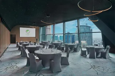 a restaurant with tables and chairs in a room with windows at Element Kuala Lumpur in Kuala Lumpur