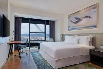 a hotel room with a bed and a desk and a window at Element Kuala Lumpur in Kuala Lumpur