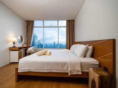 a bedroom with a large bed with a large window at The Penthouse KLCC in Kuala Lumpur