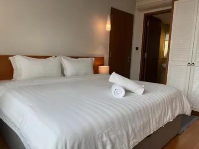a large white bed with a white towel on it at Stella Maison KLCC in Kuala Lumpur