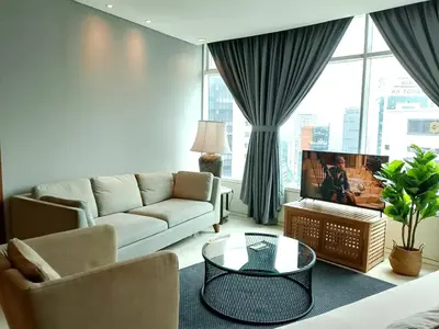 a living room with a couch and a tv at Stella Maison KLCC in Kuala Lumpur