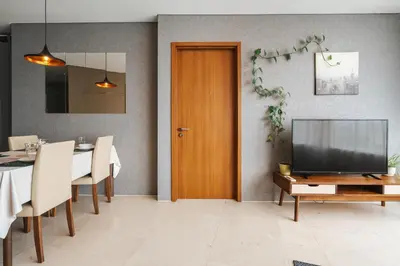 a living room with a television and a table with a dining room at Vortex KLCC Apartments in Kuala Lumpur
