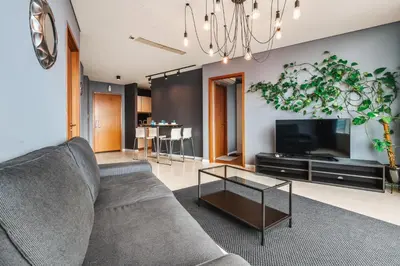 a living room with a couch and a tv at Vortex KLCC Apartments in Kuala Lumpur