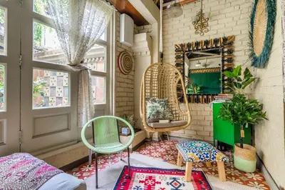 a room with two chairs and a mirror at Classic Malay House in KL City Centre in Kuala Lumpur